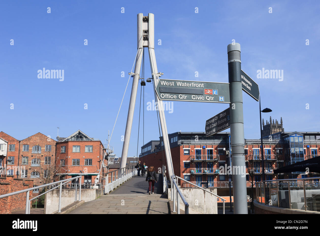 Brewery Wharf, Leeds, Yorkshire, England, UK. Tourist direction sign by Centenary Bridge footbridge crossing the River Aire Stock Photo