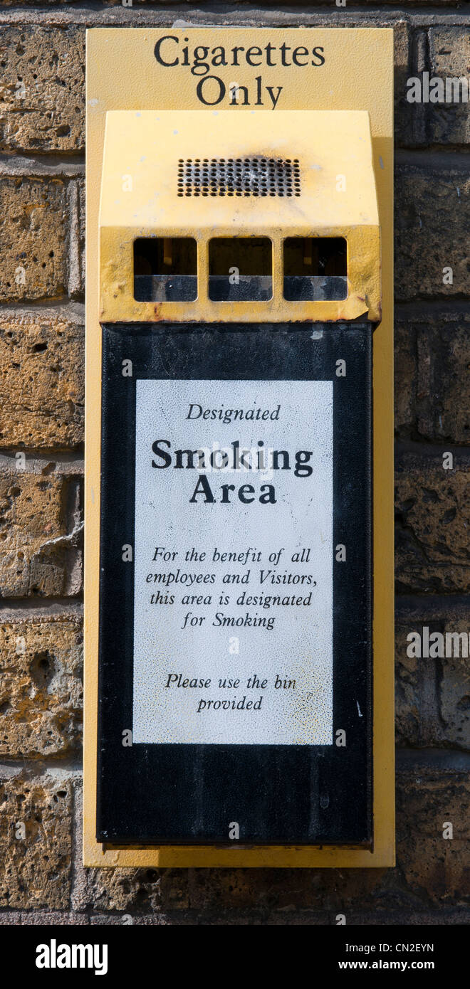 Wall mounted ash tray in a designated smoking area. Stock Photo