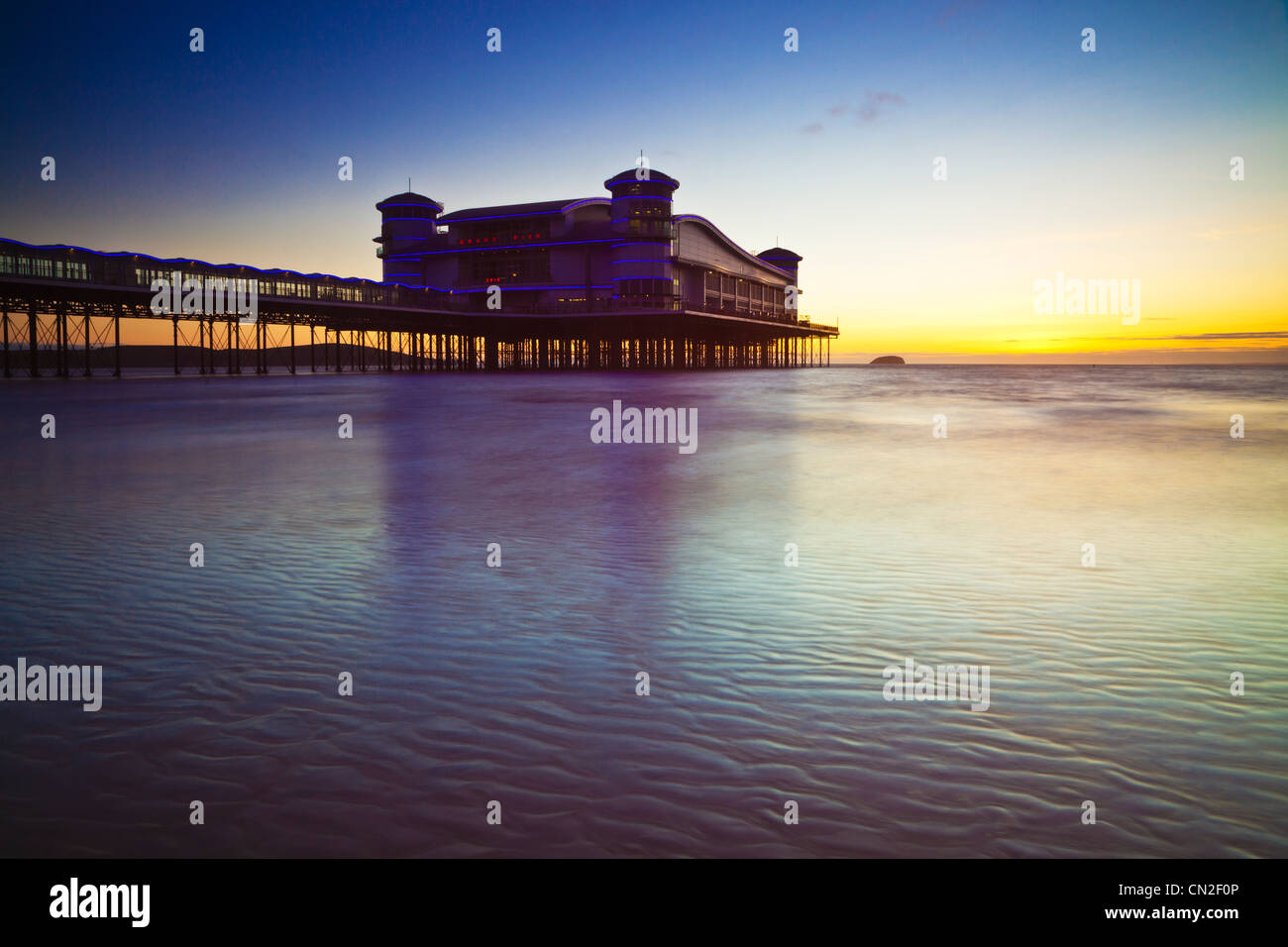 Sunset over the Grand Pier at Weston-Super-Mare, Somerset, England, UK, a long exposure shot to smooth the water. Stock Photo