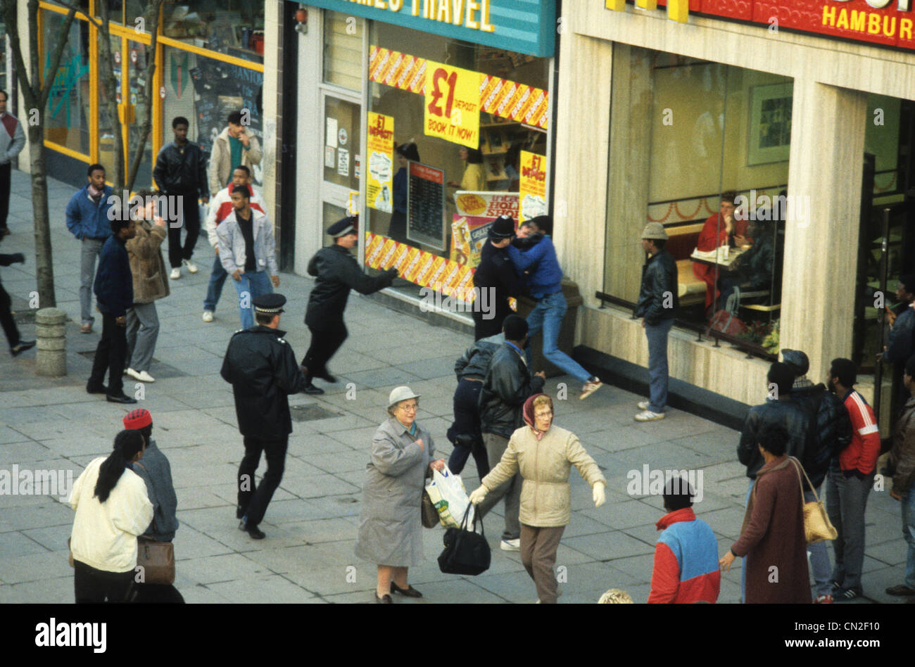 Two frightened women shoppers caught between Police officers and youths clash in Dudley Street Wolverhampton following the death of Clinton McCurbin 20/2/87 Stock Photo