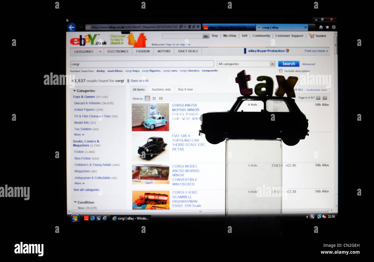 VINTAGE MODEL CAR WITH LETTERS SAYING TAX WITH EBAY COMPUTER PAGE RE ONLINE SELLING EBAY SELLERS TAXATION SELLERS INCOME TAX UK Stock Photo
