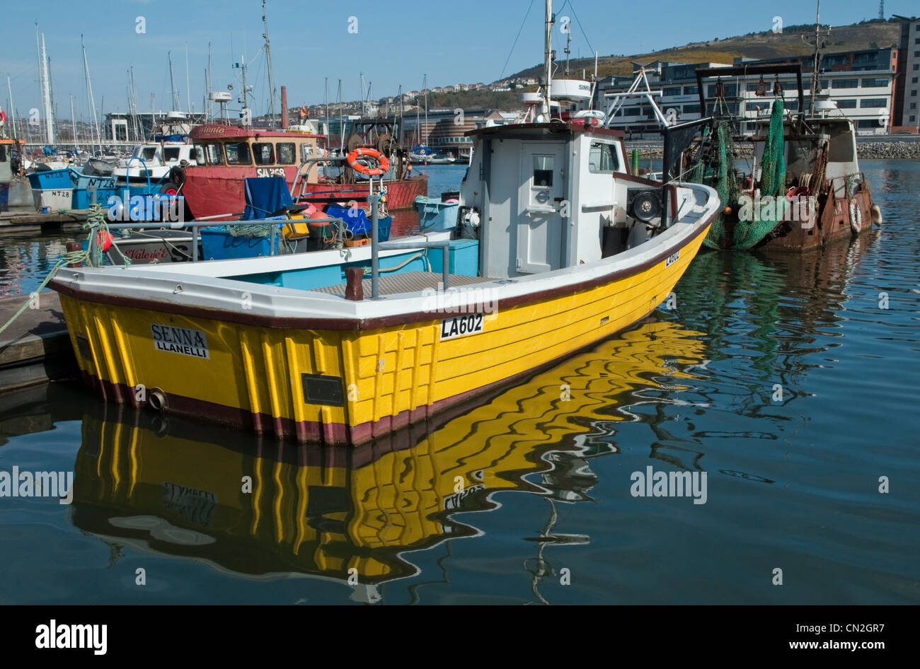 Swansea Marina (Fishing Boat Quarter) with yellow fishing boat and its reflection in foreground