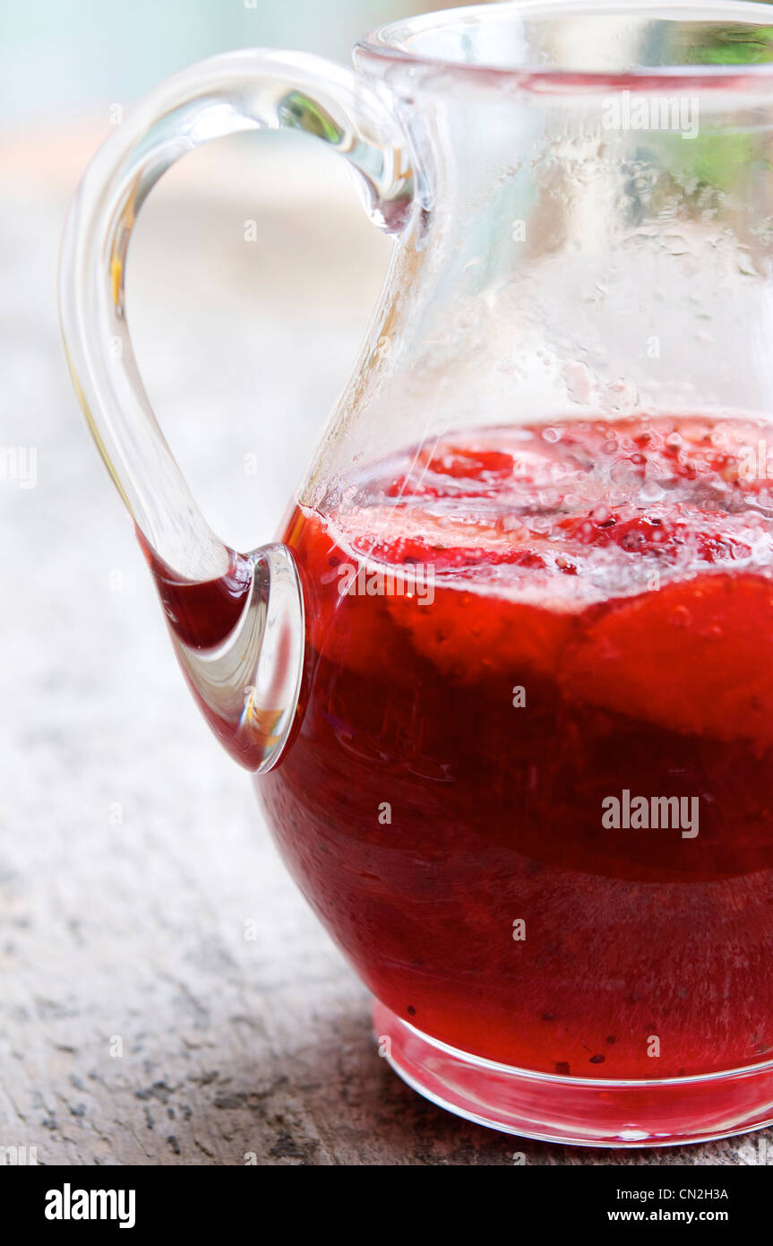 Strawberry syrup for pancakes in a glass carafe. Stock Photo