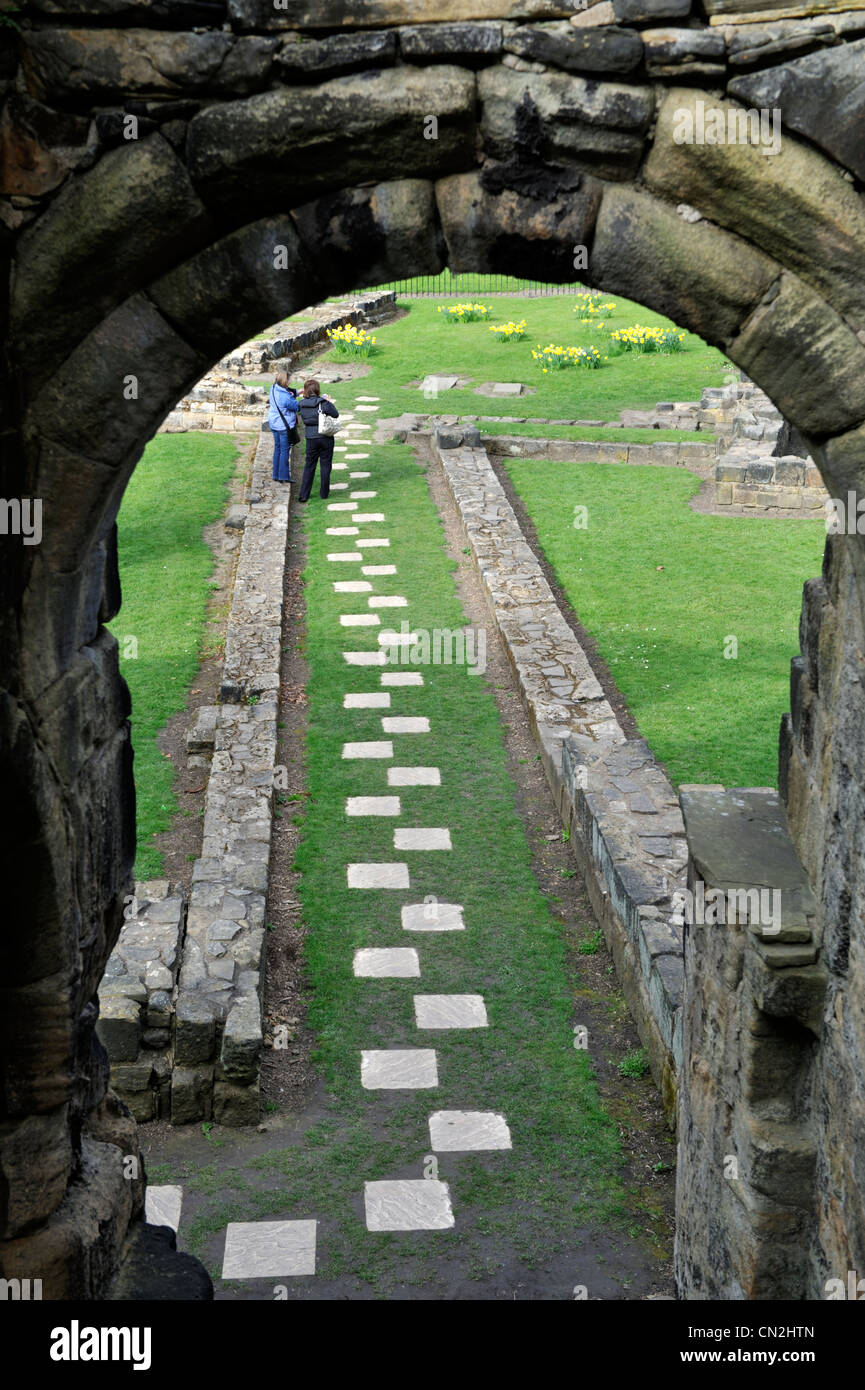 Stone archways and path in Kirkstall Abbey, ruins of Cistercian