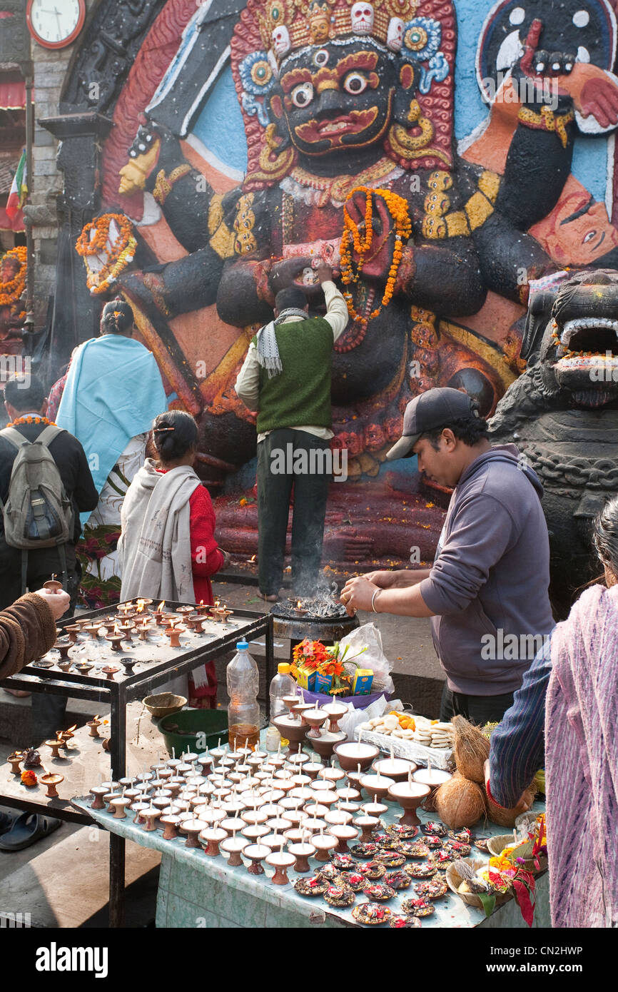 Devotees at Kala Bhairab sculpture in Durbar Square - Kathmandu, Bagmati Zone, Kathmandu Valley, Nepal Stock Photo