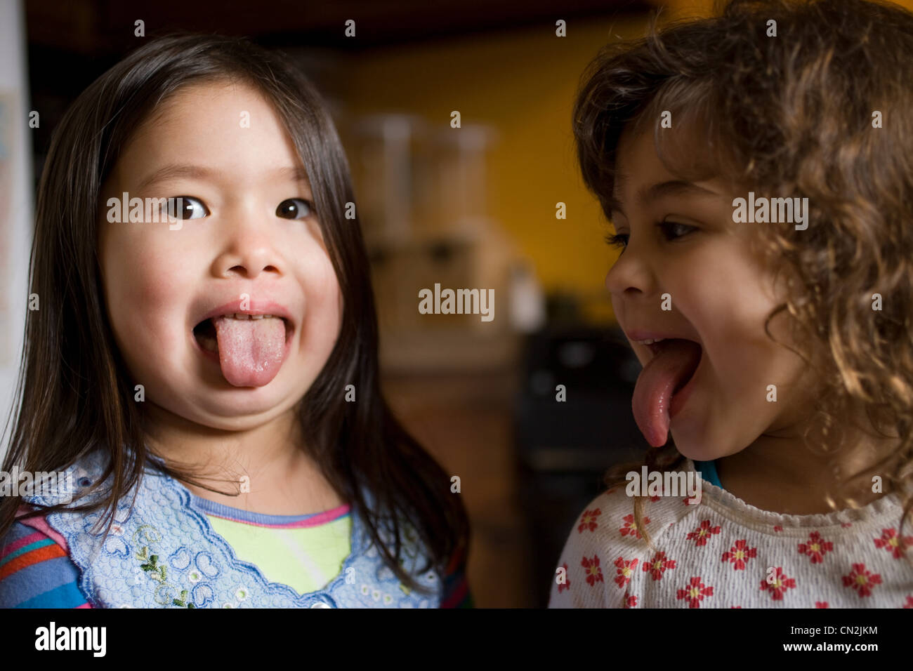 Two young girls sticking out their tongues Stock Photo 47387080 Alamy