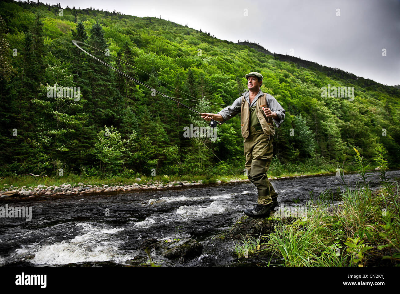 Fly fisherman in Margaree River, Cape Breton Island, Nova Scotia Stock Photo