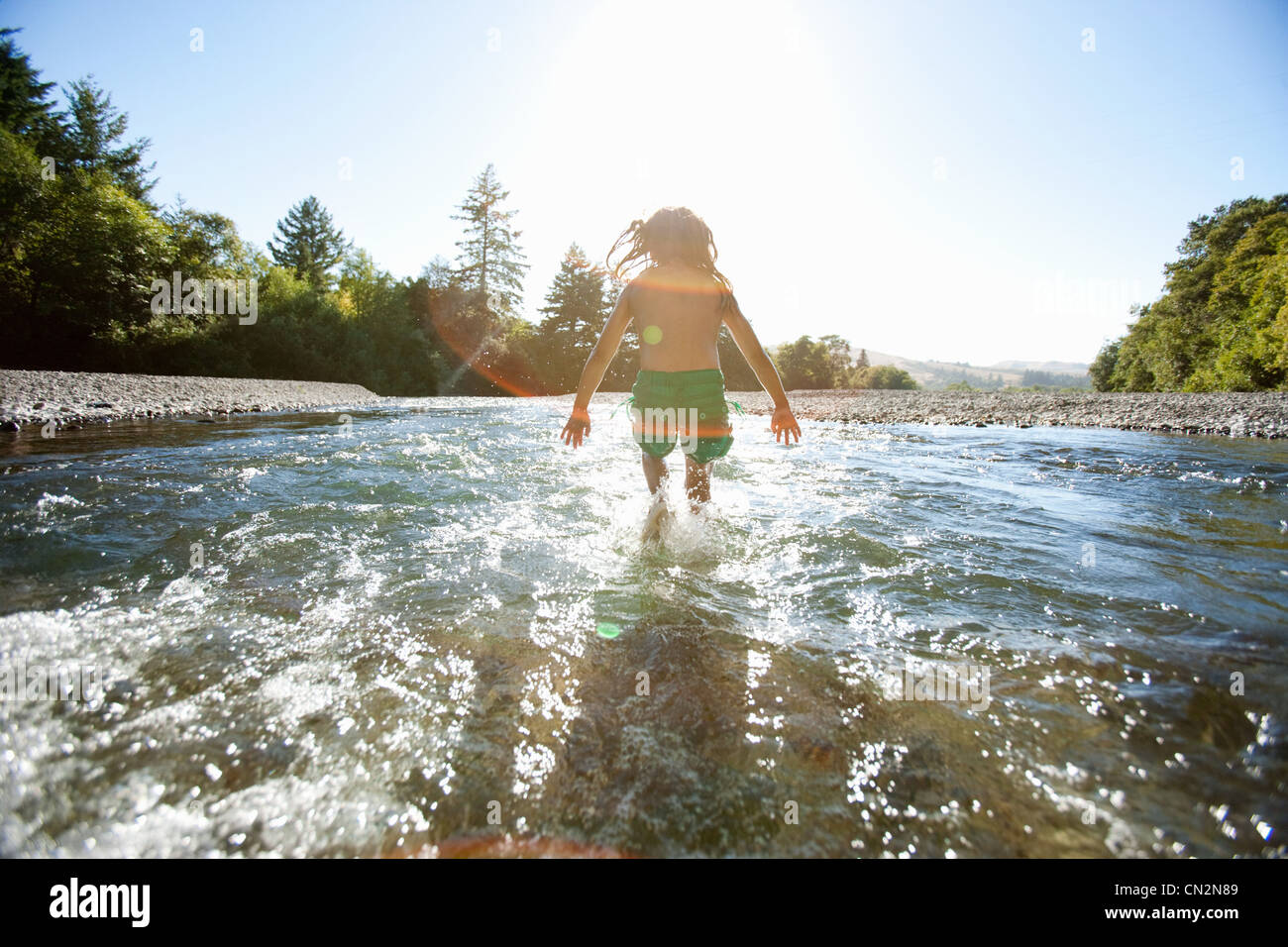 Girl Jumping In River Stock Photo Alamy