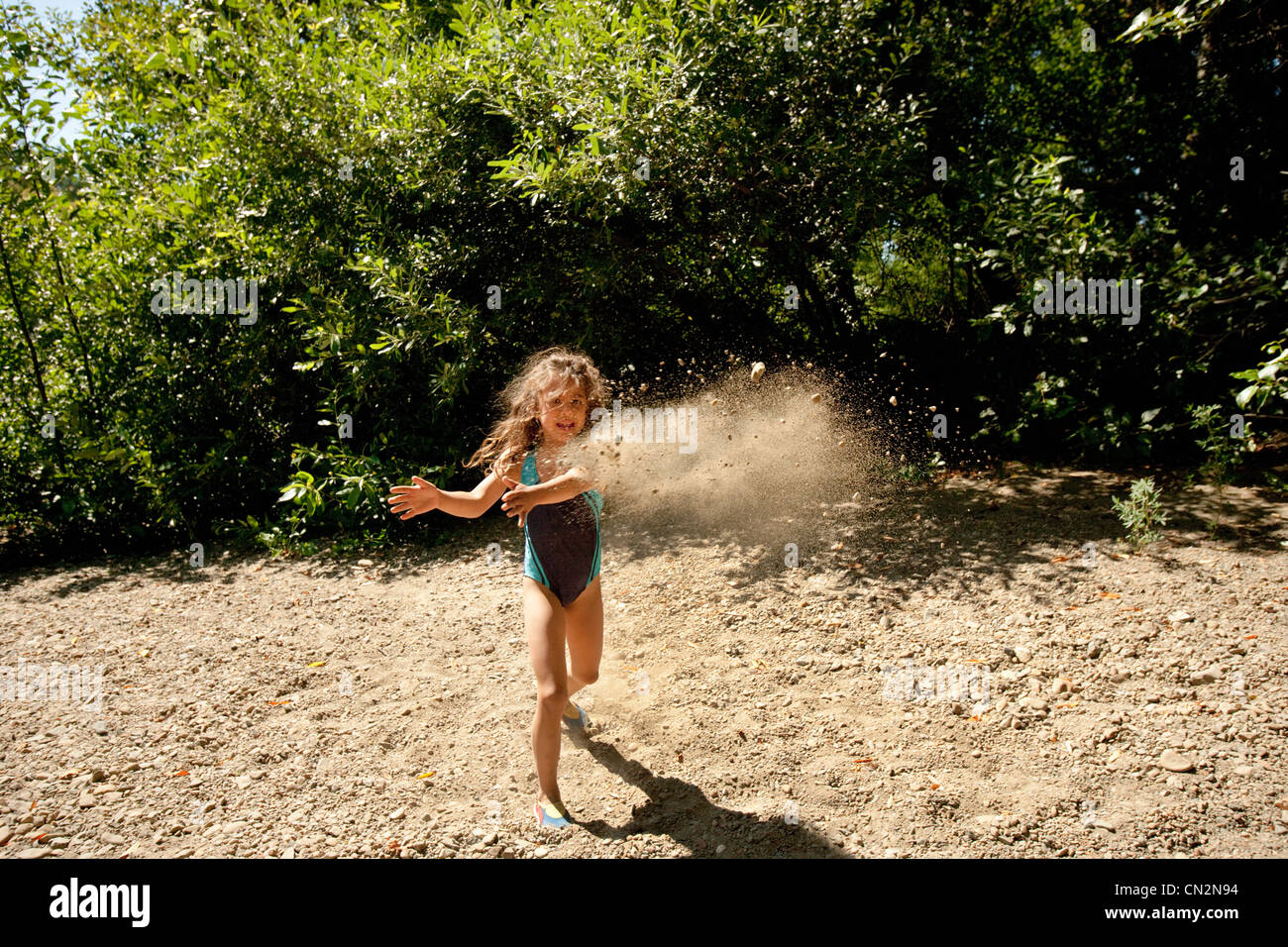 Girl throwing dirt Stock Photo Alamy