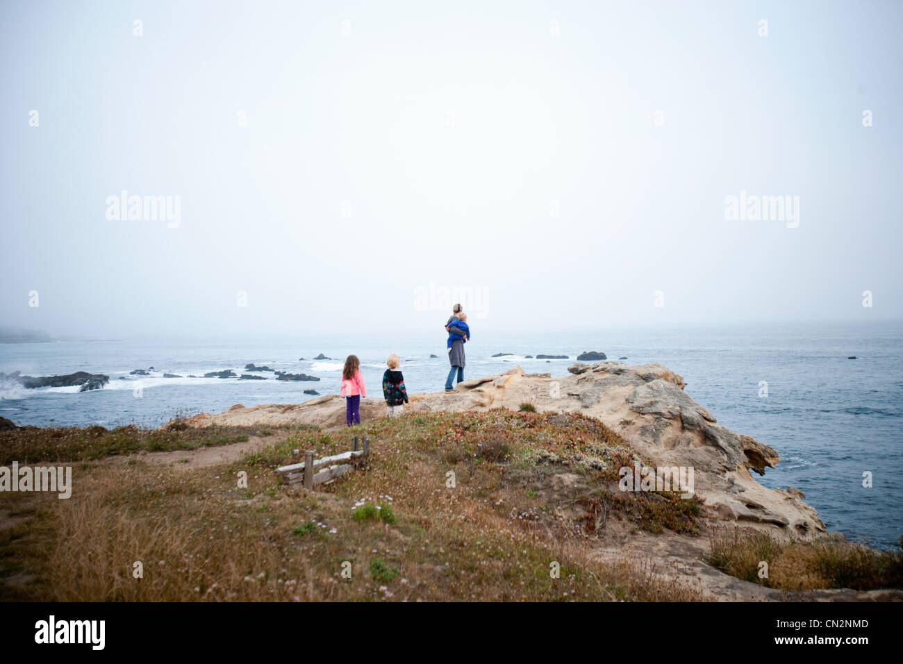 Family looking at view of coast Stock Photo