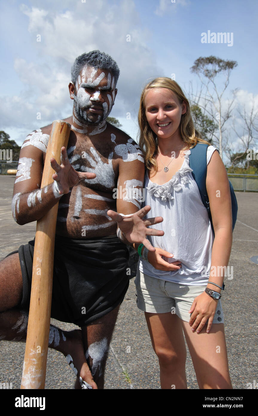 Teenage girl posing with painted aborigine man at Echo Point lookout, Katoomba, Blue Mountains, New South Wales, Australia Stock Photo