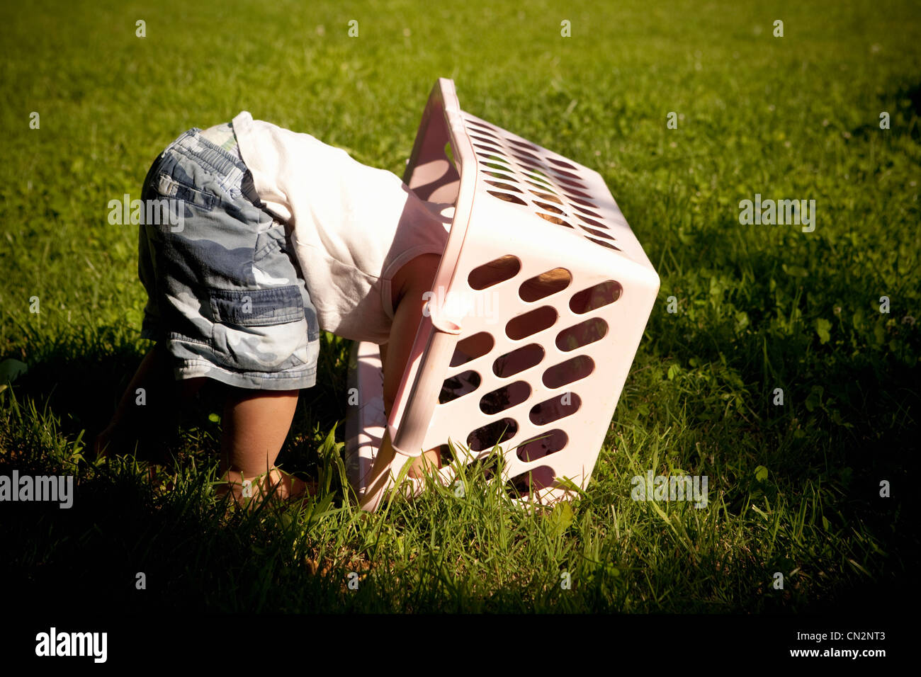 Boy with laundry basket on head Stock Photo Alamy
