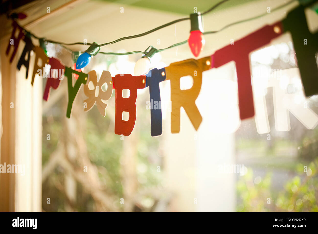 Birthday banner hanging in window Stock Photo