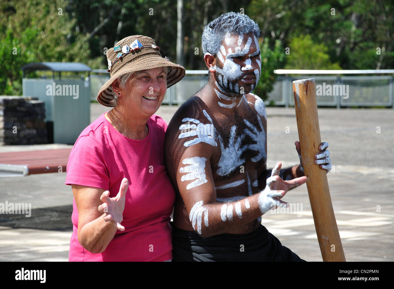 Tourist posing with painted aborigine man at Echo Point lookout, Katoomba, Blue Mountains, New South Wales, Australia Stock Photo