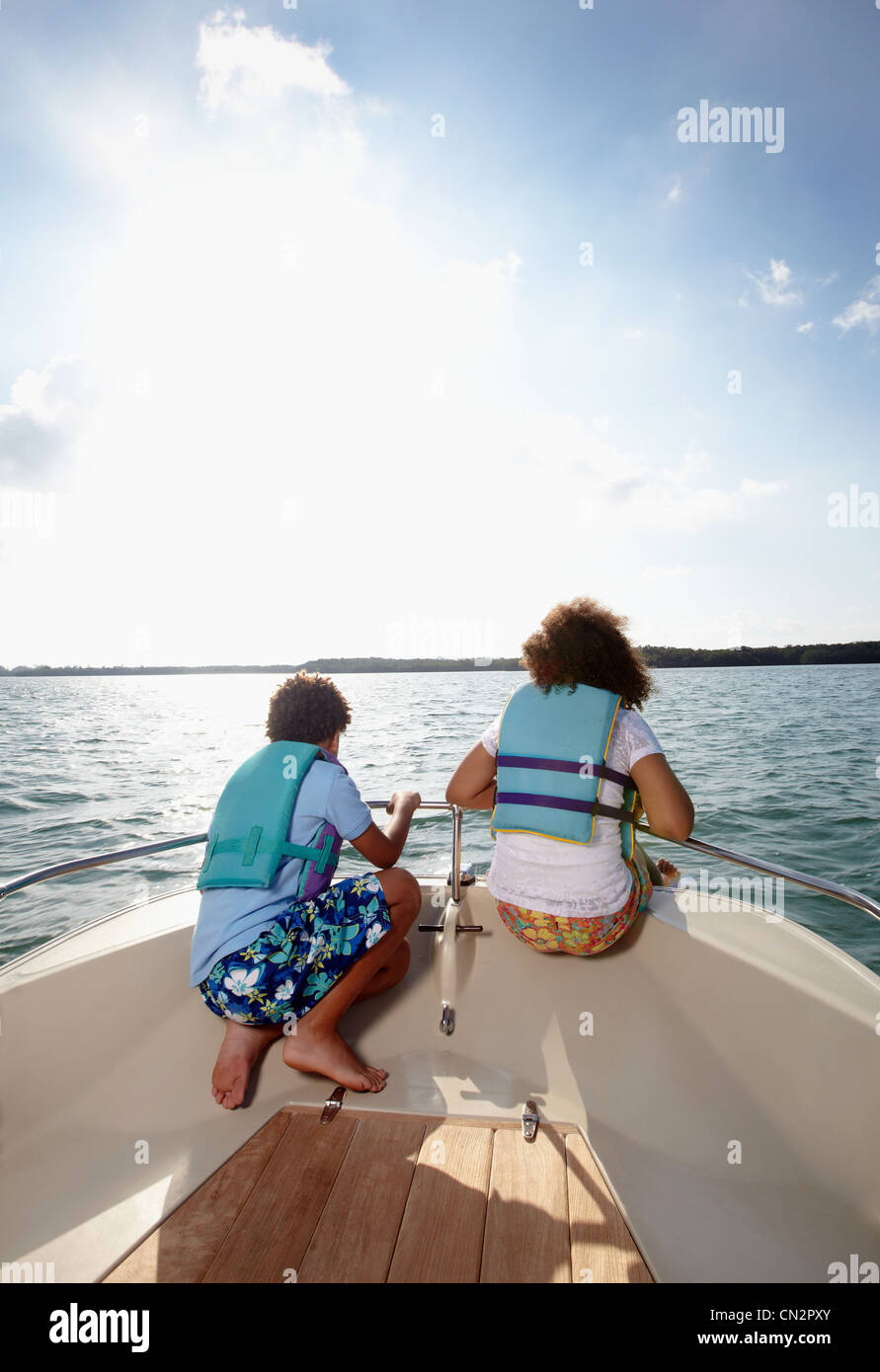 Two children looking at view from motorboat Stock Photo