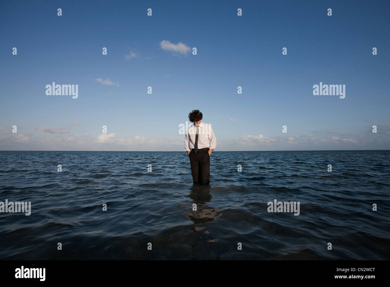 Businessman standing in sea Stock Photo