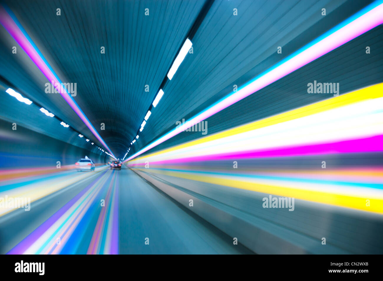Abstract speed motion in urban highway road tunnel, blurred motion toward the light Stock Photo