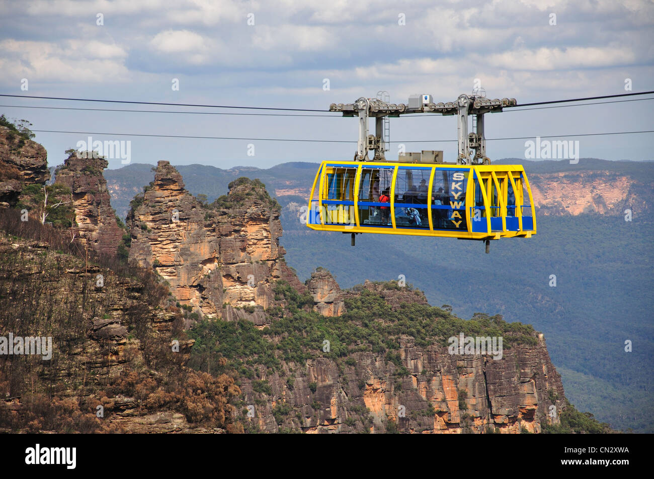 View of Scenic Skyway cablecar with 'The Three Sisters' behind, The Jamison Valley, Blue View of Scenic Skyway cablecar with 'The Three Sisters' behind, The Jamison Valley, Blue