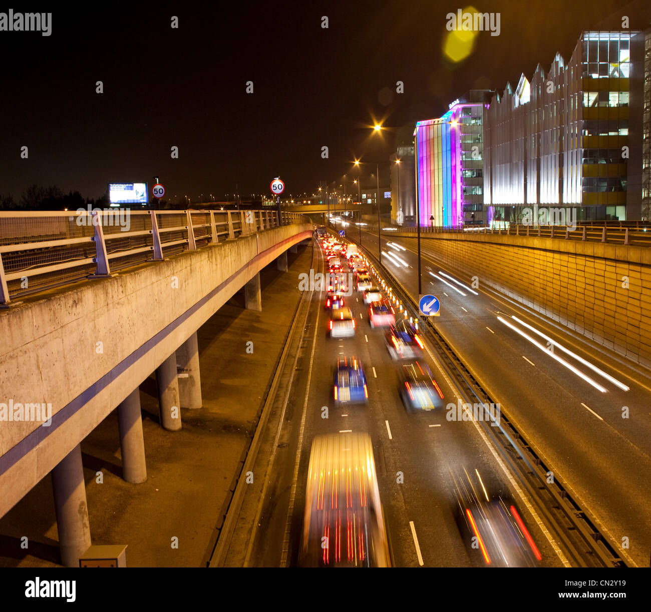 Traffic on road in urban scene at night, London, England Stock Photo