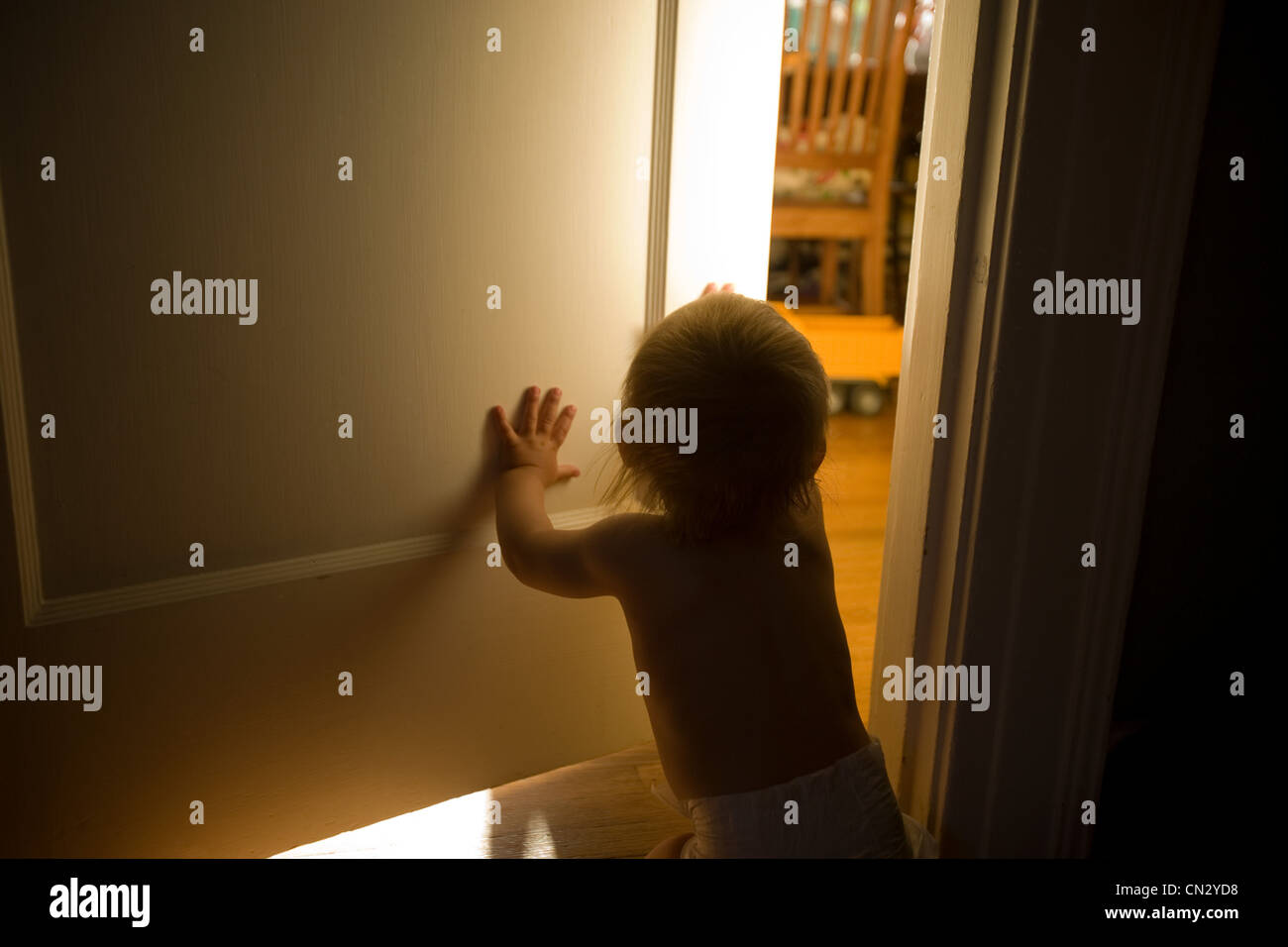 Baby boy opening door Stock Photo Alamy