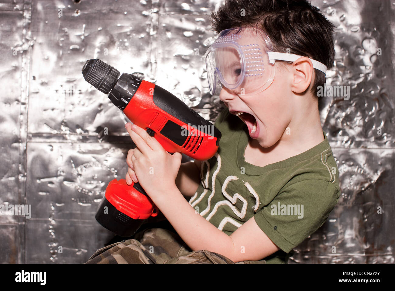 Boy with power tool and safety goggles Stock Photo