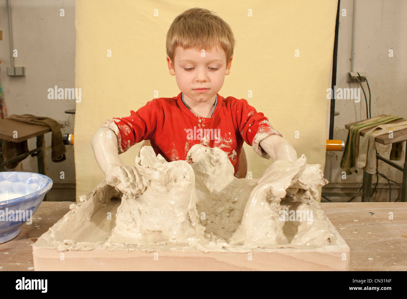 young boy working at the clay-field Stock Photo