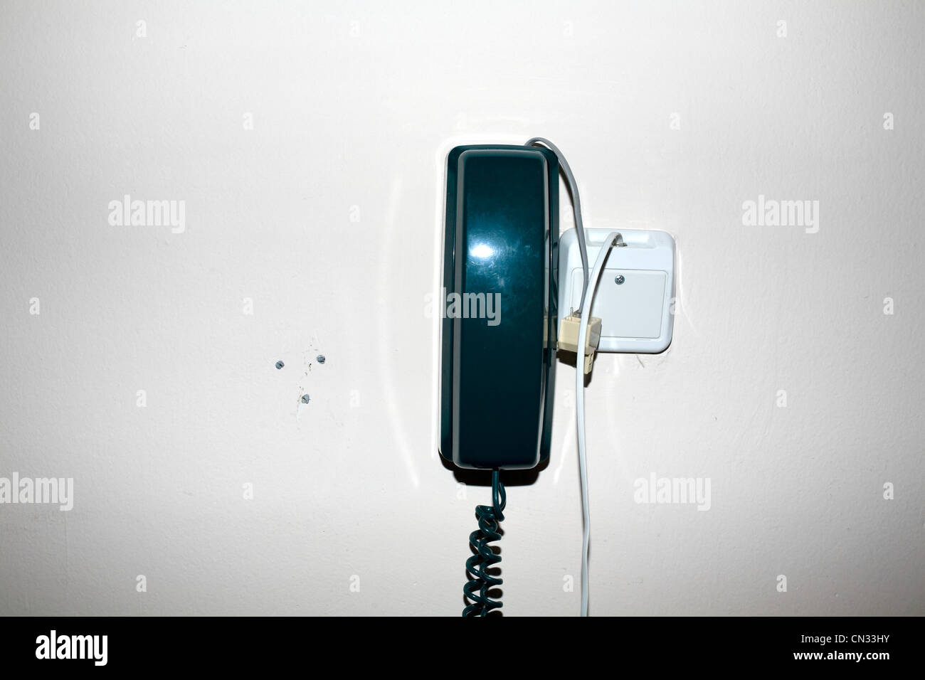 Landline phone on wall Stock Photo