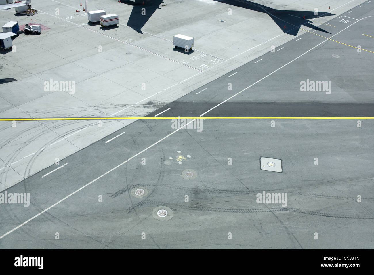Airport runway with shadow of plane Stock Photo