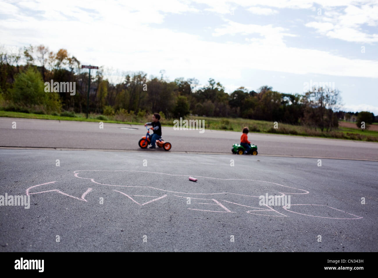 Two boys riding tricycles Stock Photo