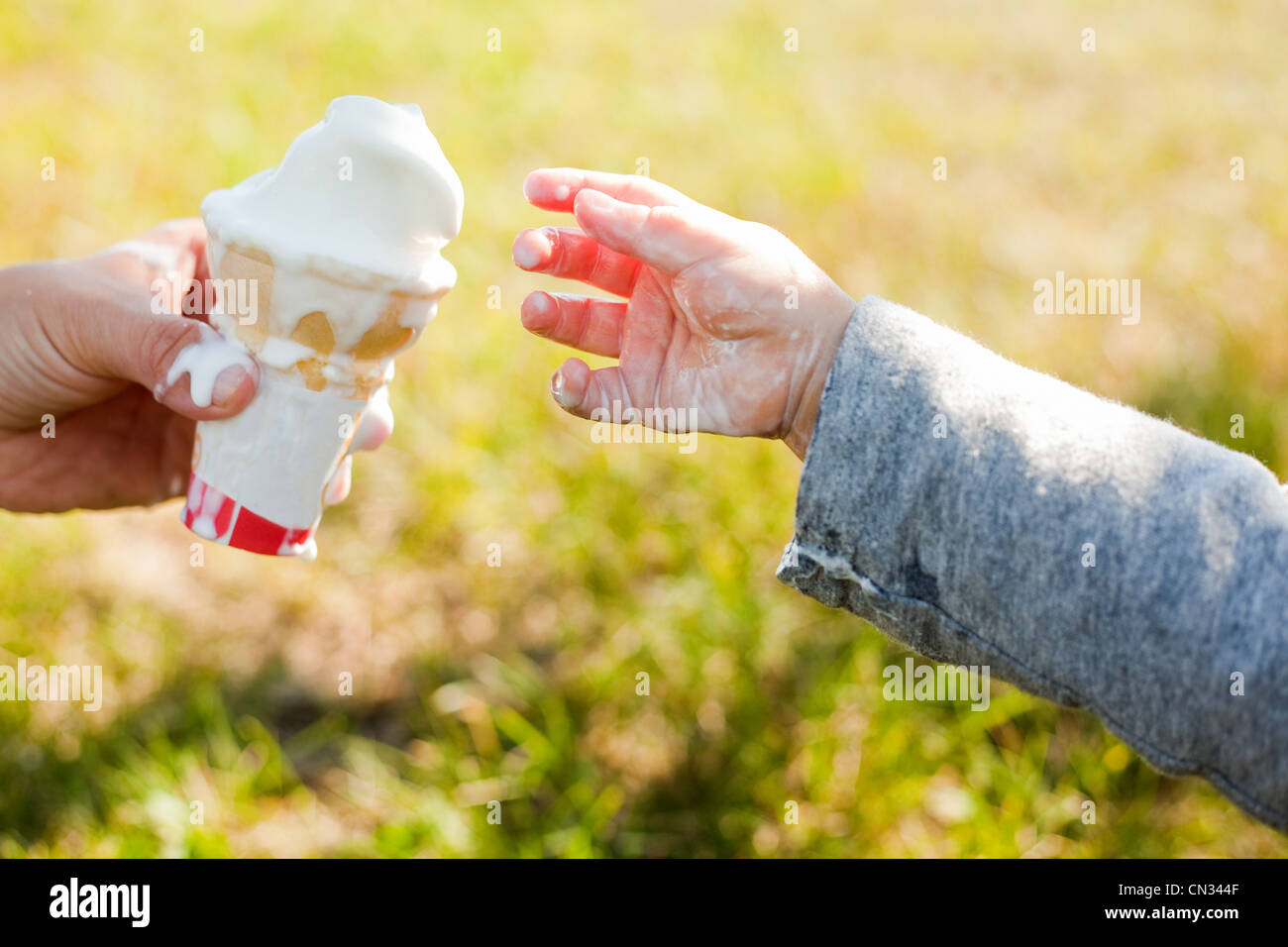 Toddler taking ice cream cone Stock Photo Alamy