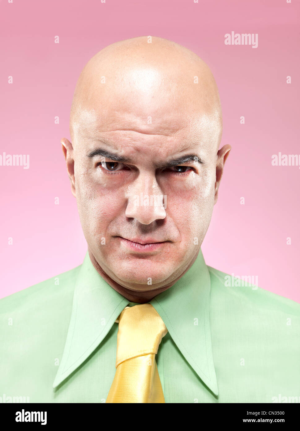 Bald man frowning Stock Photo