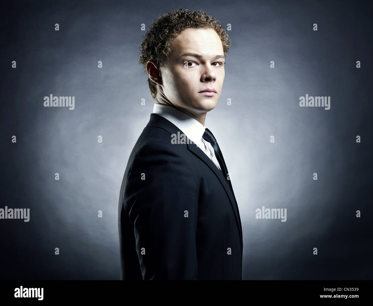 Portrait of handsome stylish man in elegant black suit Stock Photo - Alamy