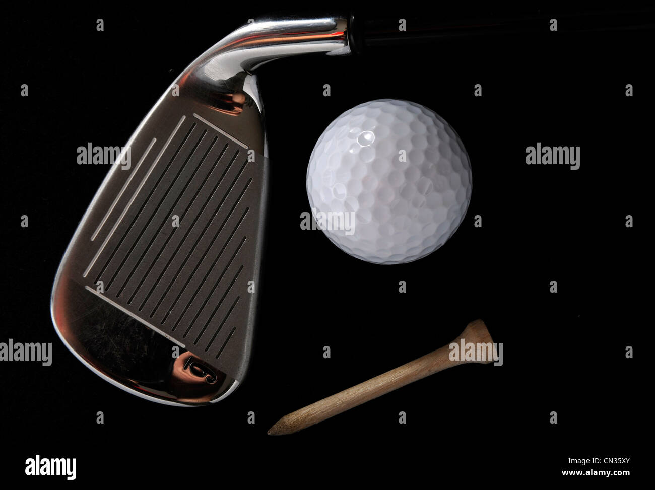Golf club with ball and tee in the black background Stock Photo - Alamy
