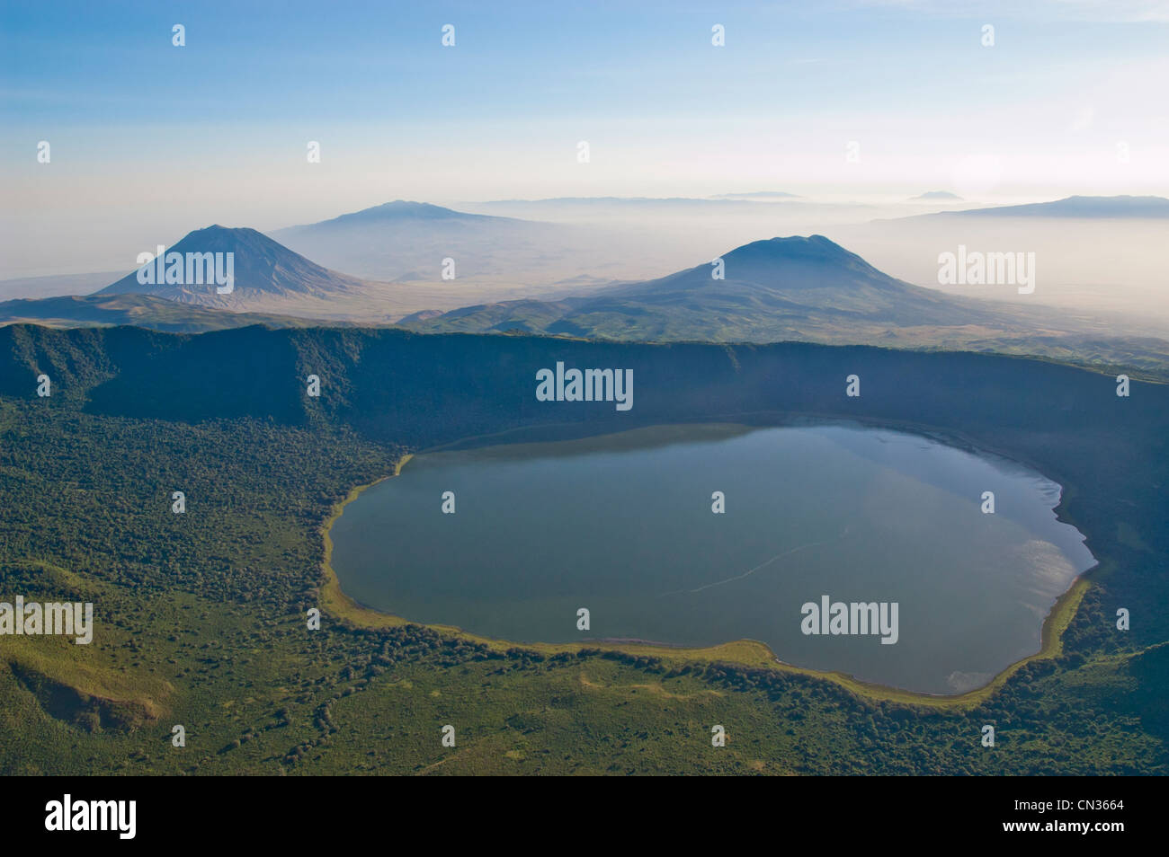 Empakai crater and lake, in the background Ol Doinyo Lengai (left) and Keremasi (right), aerial view, Tanzania Stock Photo