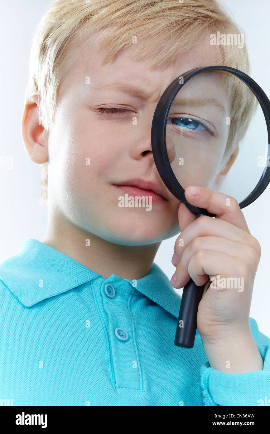 Portrait of a kid looking through magnifying glass Stock Photo Alamy