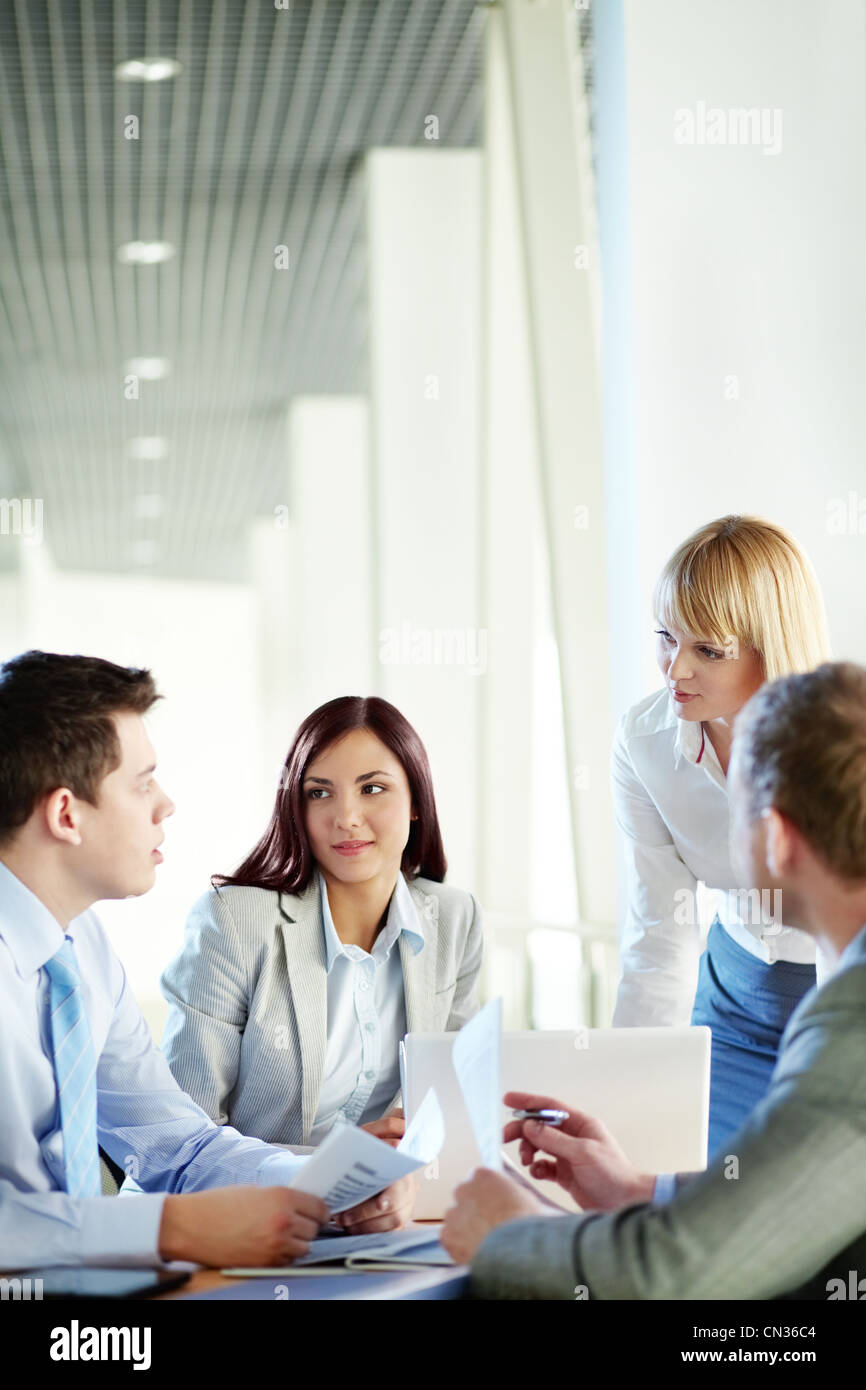 Vertical shot of business people gathered for a meeting Stock Photo Alamy