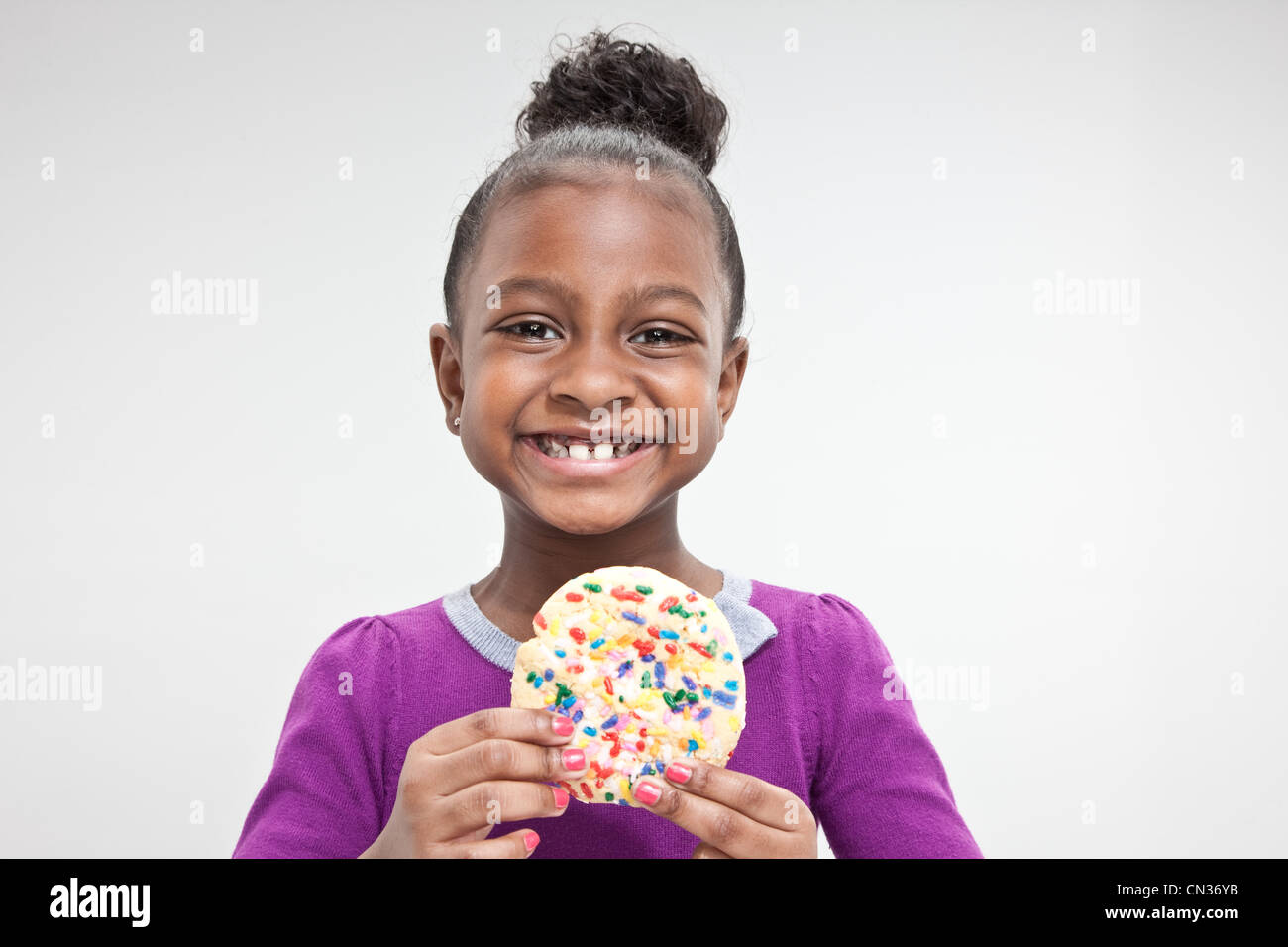 Girl holding cookie Stock Photo Alamy