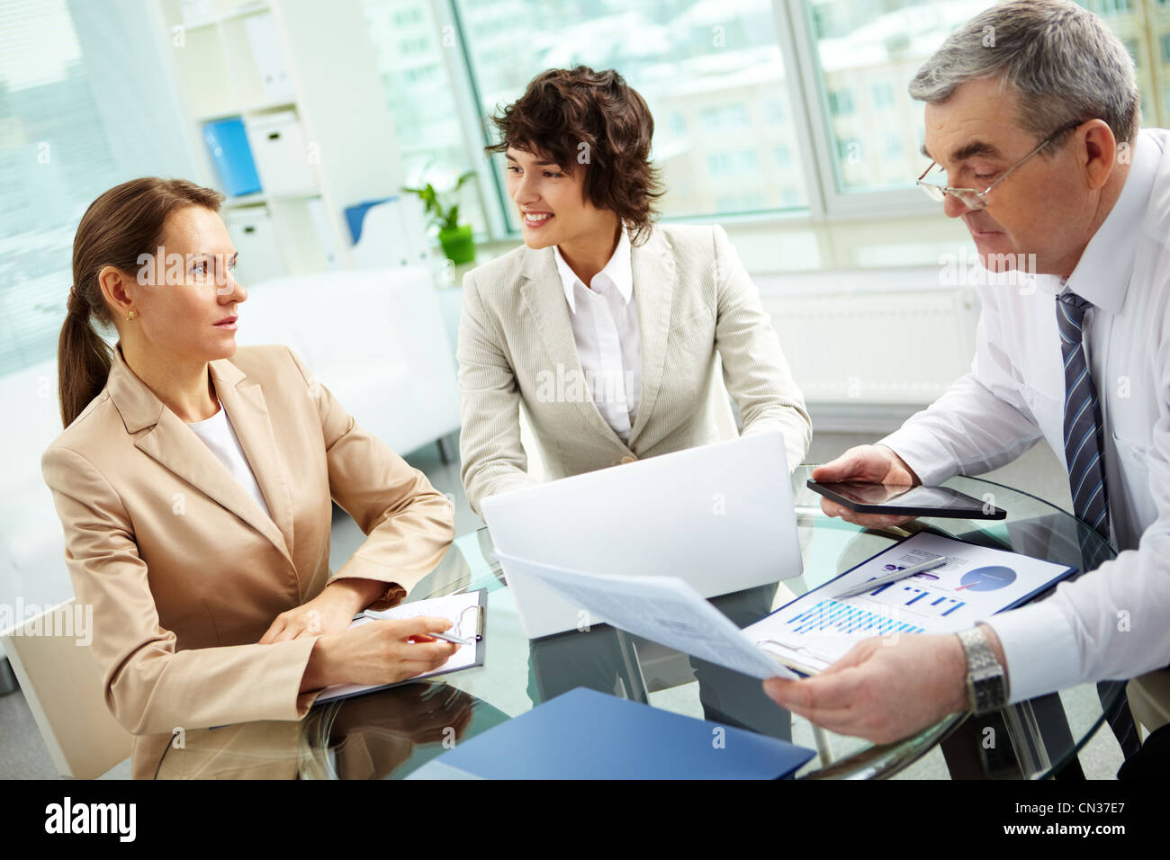 Business group of diverse age discussing some matters, tilt up Stock Photo
