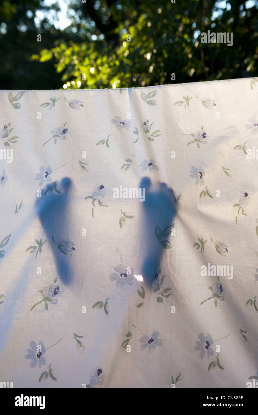 Child's feet in homemade den made from sheet Stock Photo Alamy