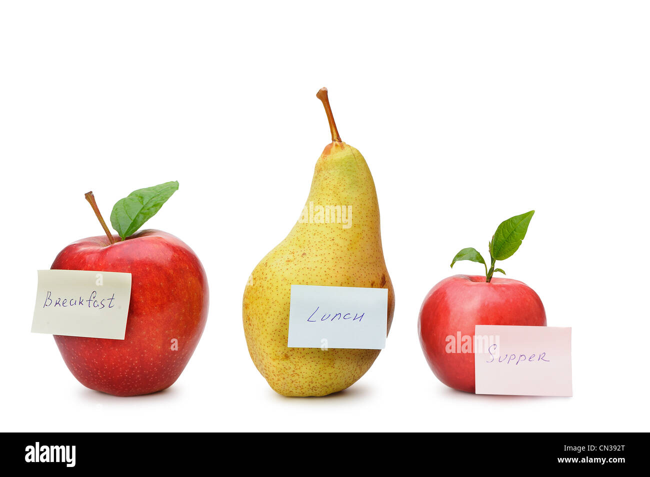 Pear and red apples with paper notes. Inscriptions on the notes Breakfast, lunch and dinner. The concept of diet Stock Photo