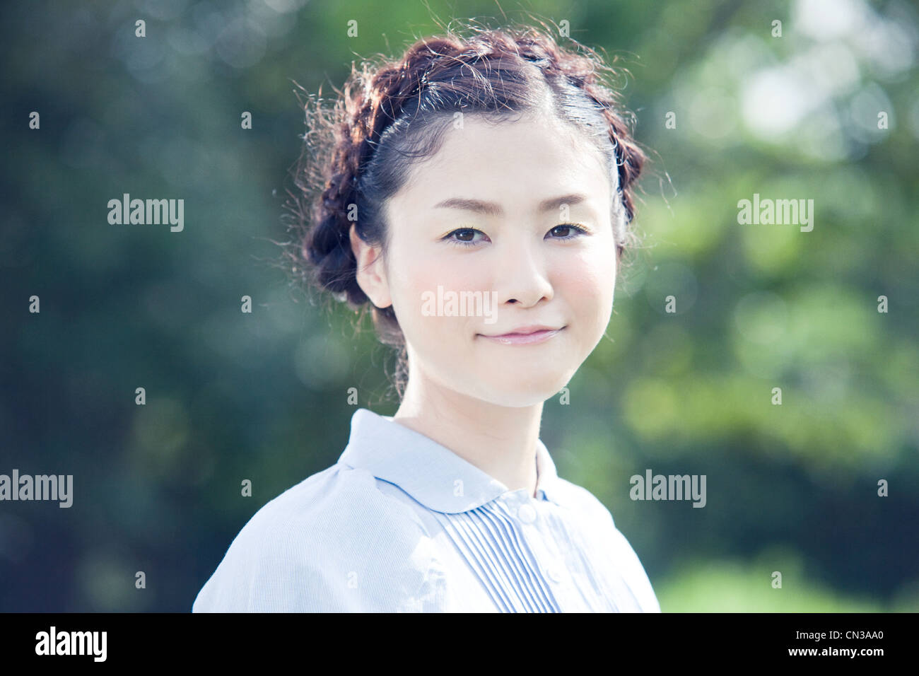 https://c8.alamy.com/comp/CN3AA0/young-woman-with-plaited-hair-portrait-CN3AA0.jpg