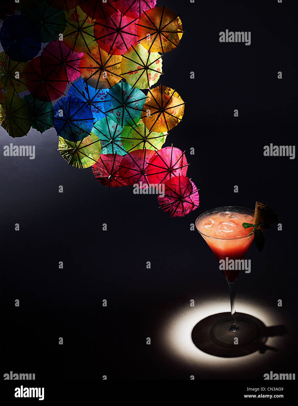 Cocktail and colourful cocktail umbrellas, studio shot Stock Photo