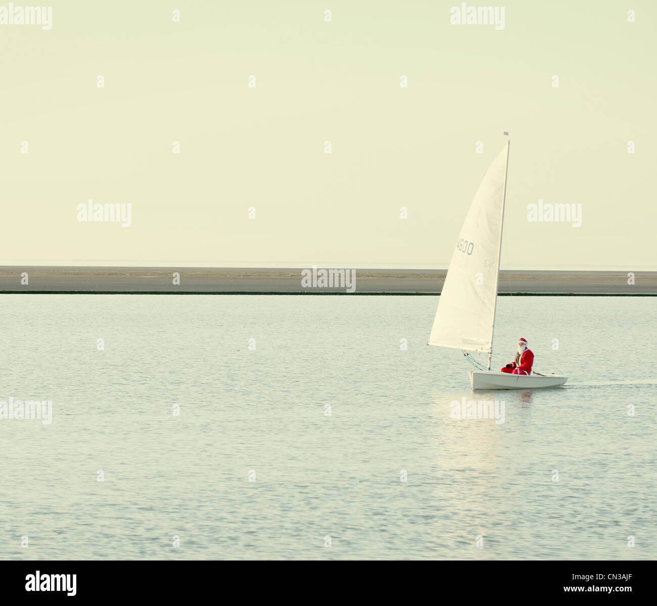 Person dressed up as santa claus in boat on lake Stock Photo
