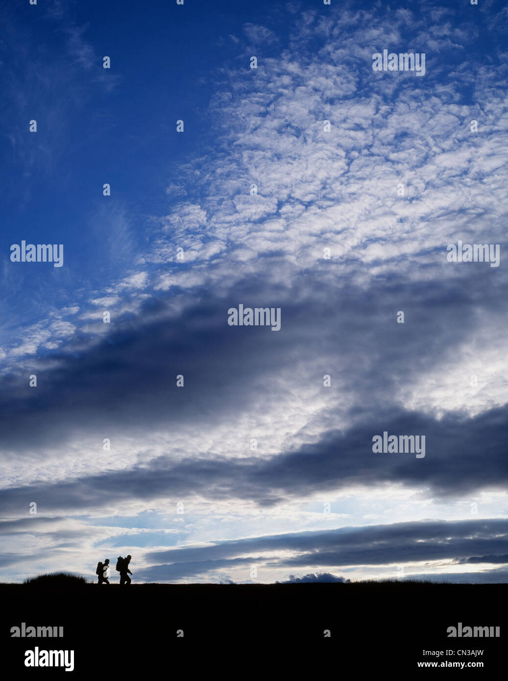 Two people hiking, silhouette Stock Photo