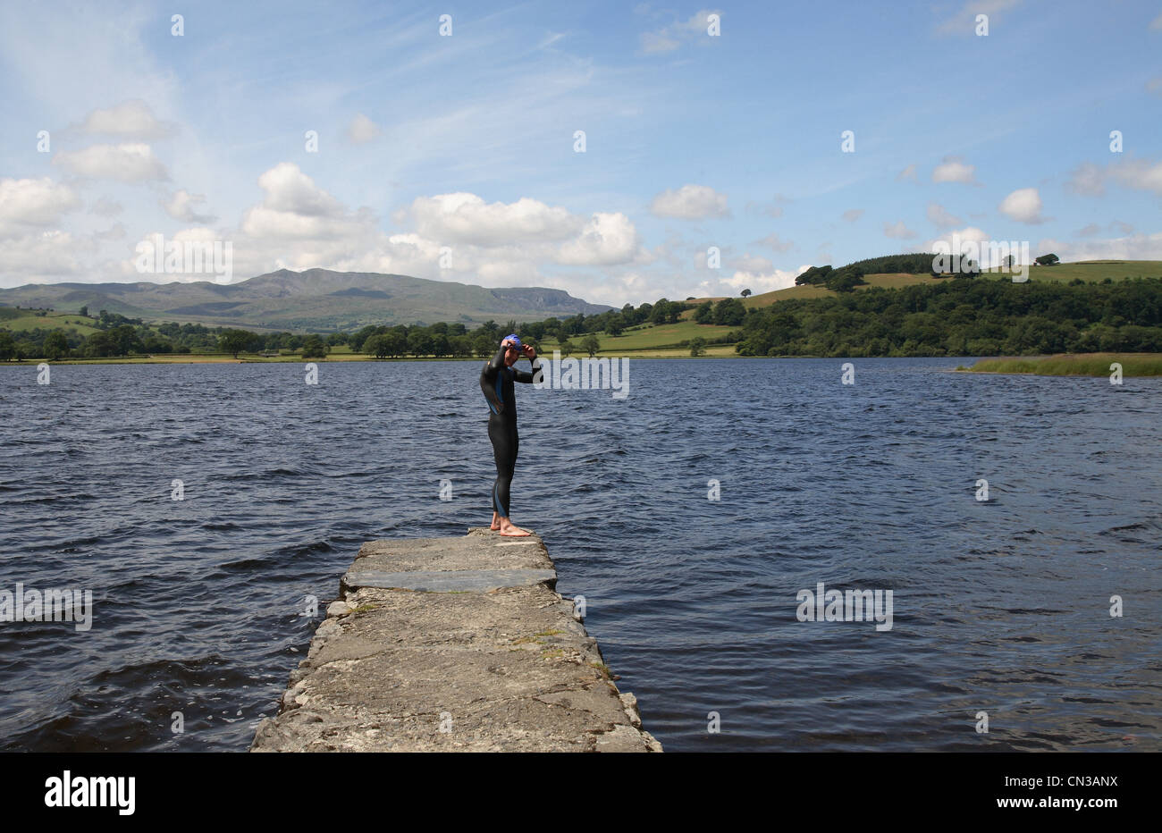 Triathlete swimmer standing on jetty Stock Photo