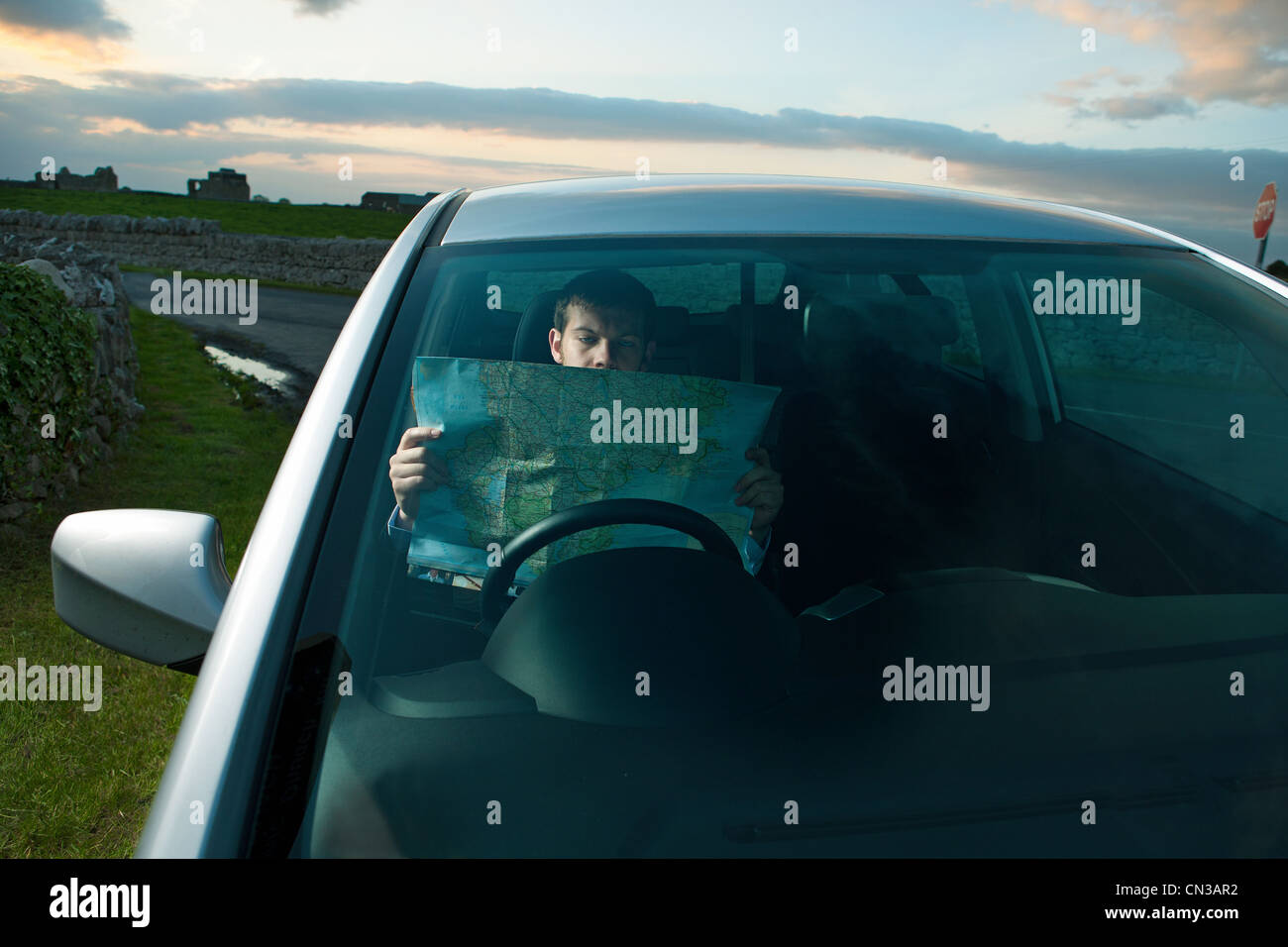 Businessman reading map in car Stock Photo