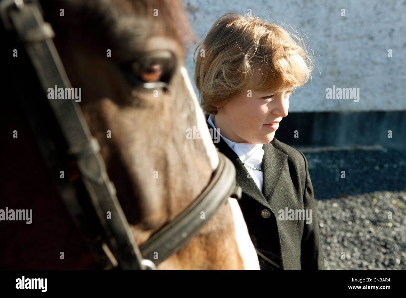 Boy standing with horse Stock Photo