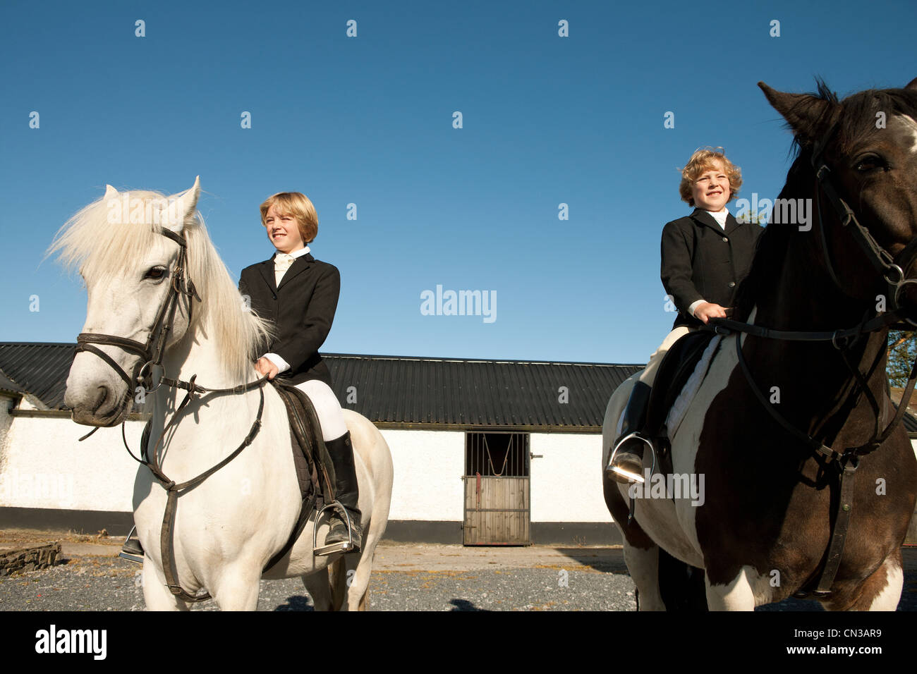 Two boys riding horses Stock Photo