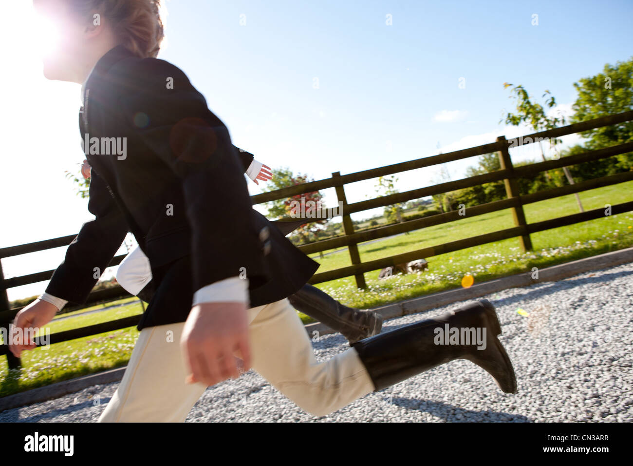 Boys running in horse riding clothes Stock Photo
