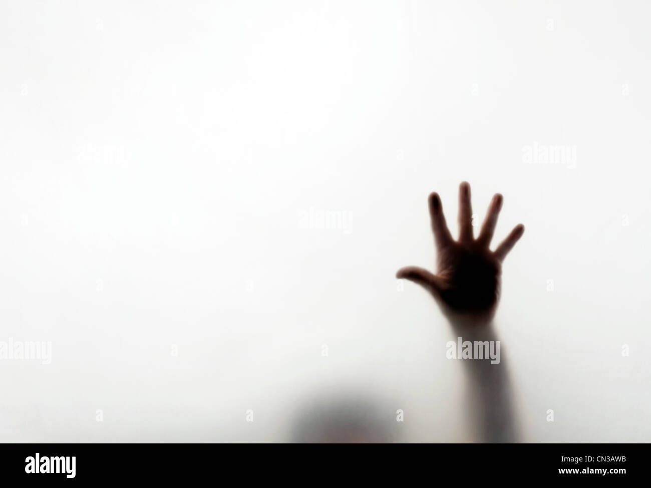 Man pressing hand against window Stock Photo